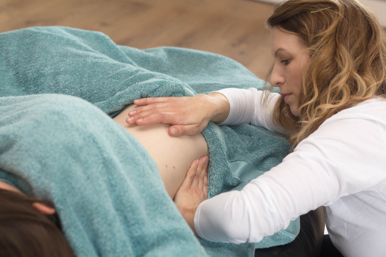Photo of pregnant woman receiving a massage